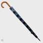 Blue and black checkered umbrella with wooden handle on a light gray background